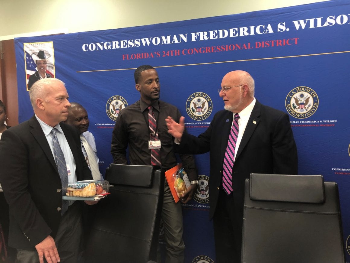 Ron Ledain, Hudes Desrameaux, Doug Stelle from Care Resource speaking with Dr. Robert Redfield, Director of the Centers for Disease Control and Prevention.
