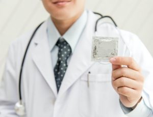 Doctor holding condom