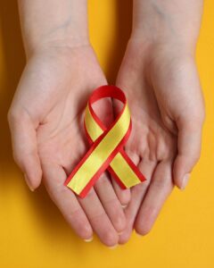 Hands holding a Hepatitis C Awareness ribbon