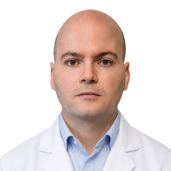 A photo of Giraldo Martija, Pharmacist, in a white lab coat against a white background.